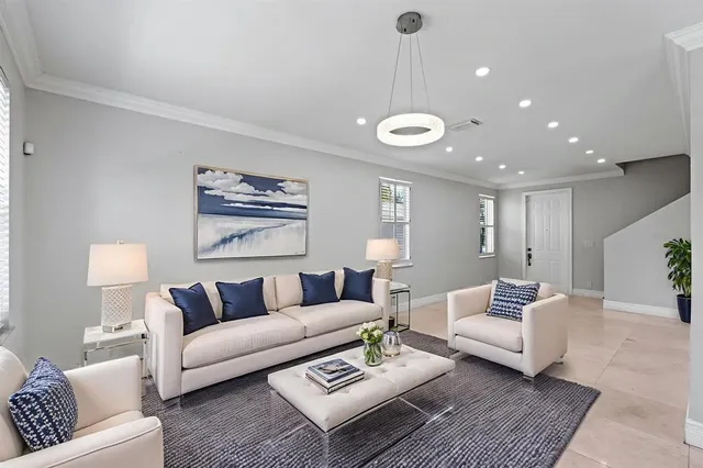 a living room with furniture and a ceiling fan