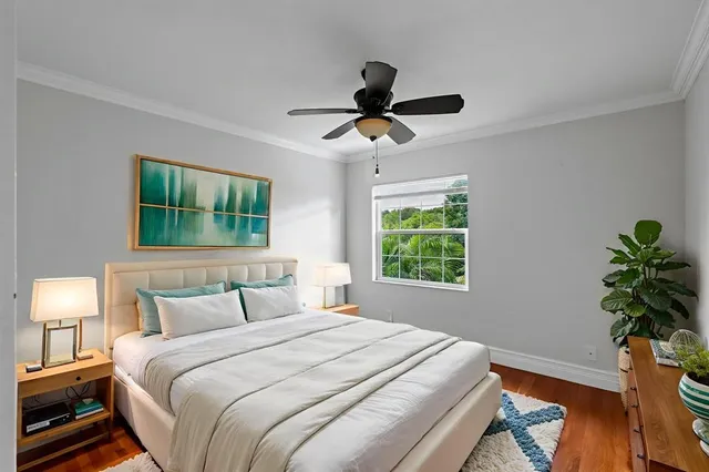 a bedroom with a bed and a potted plant