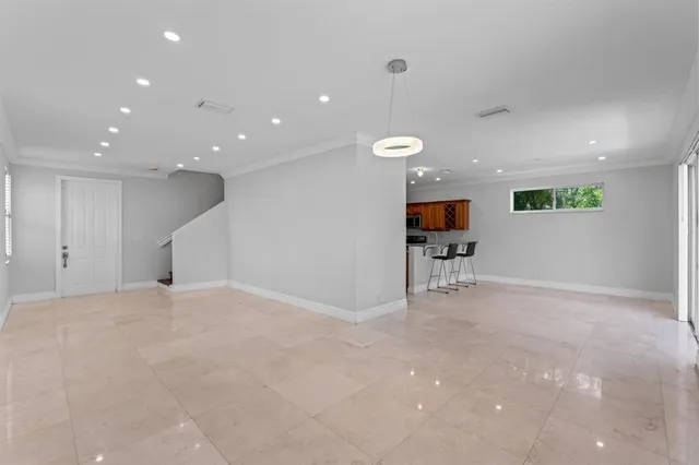 a view of a livingroom with furniture and an empty room