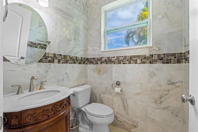 a bathroom with a sink toilet and a mirror