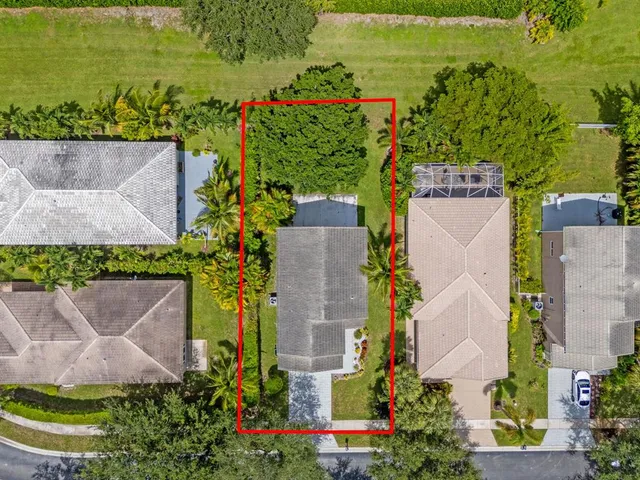 an aerial view of a house with a yard and lake view