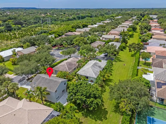 an aerial view of a house with a yard