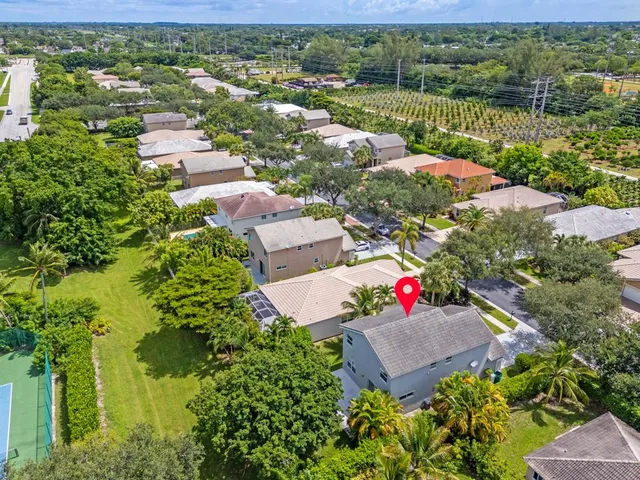 an aerial view of a house with a garden and lake view