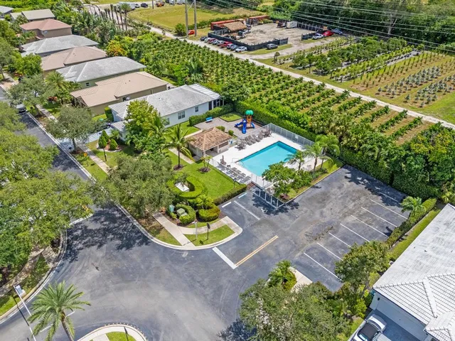 an aerial view of a house with a yard and garden