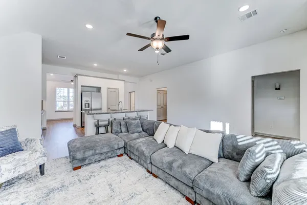 a living room with furniture and kitchen view