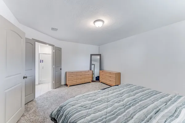 a bedroom with a large bed and a closet