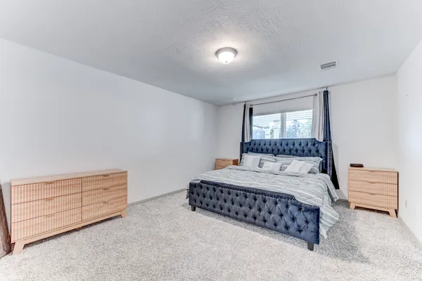 a bedroom with a bed and a dresser