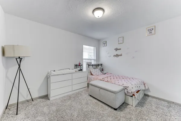 a bedroom with a bed and a table