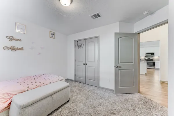 a living room with furniture and a walk in closet