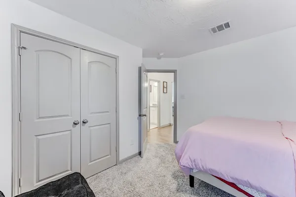 a bedroom with a bed and a closet