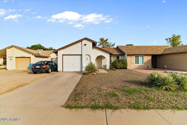 a car parked in front of white house
