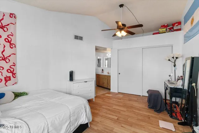 a bedroom with furniture and a flat screen tv