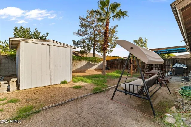 a view of a house with backyard and sitting area