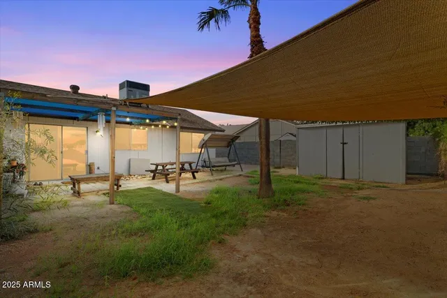 a backyard of a house with table and chairs