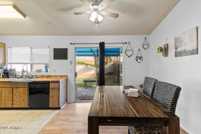 a kitchen with stainless steel appliances granite countertop a sink a stove top oven a chimney with wooden floor and cabinets