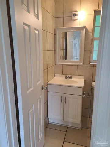 a bathroom with a sink vanity and a mirror