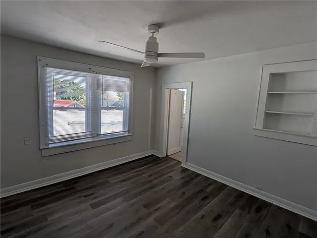 wooden floor in an empty room with a window
