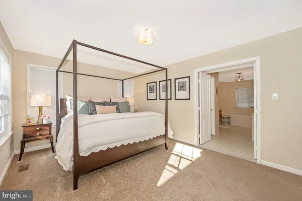 a bed room with a bed and a chair