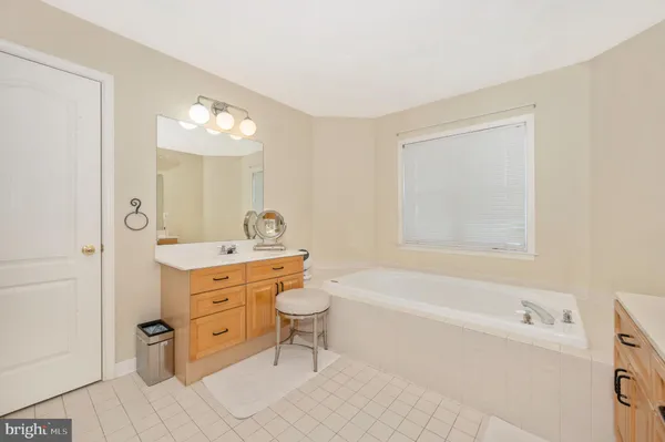 a bathroom with a granite countertop sink a toilet and bathtub