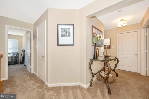 a view of a livingroom with furniture and a hallway
