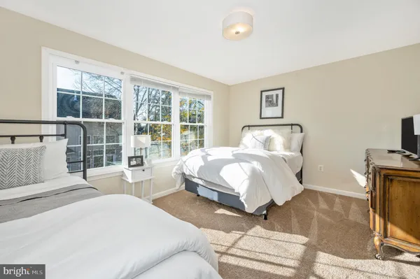 a spacious bedroom with a bed and glass windows