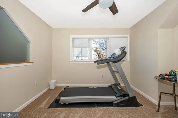 a room with gym equipment and windows