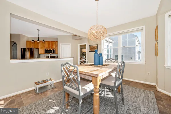 a view of a dining room with furniture wooden floor and chandelier