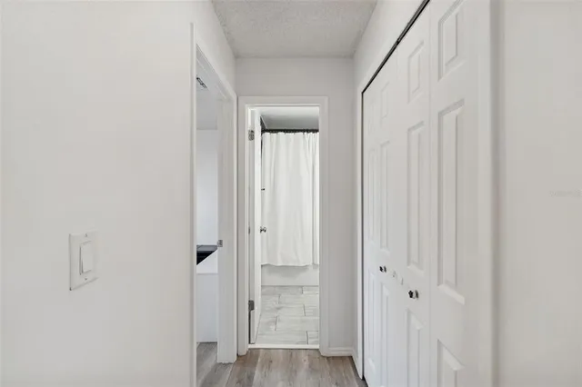 a view of a hallway with wooden floor