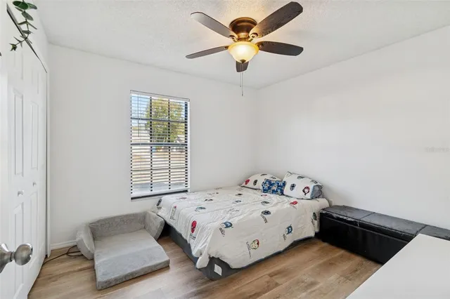 a bedroom with a bed and a chandelier