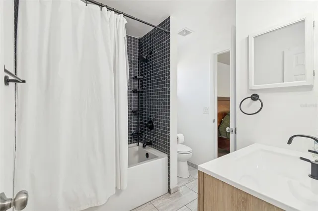 a bathroom with a bathtub and shower