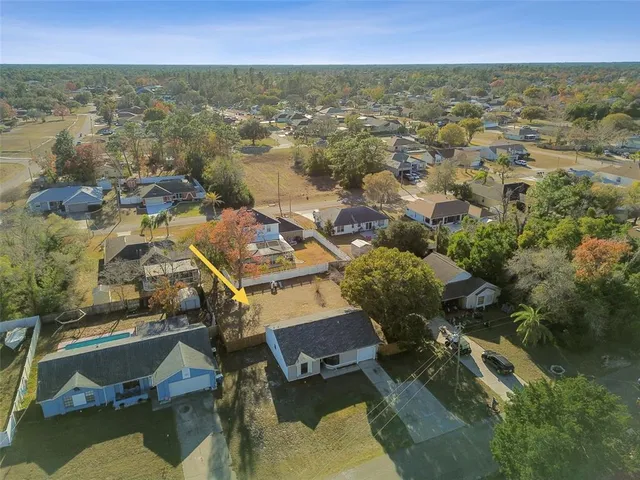 an aerial view of residential houses with outdoor space