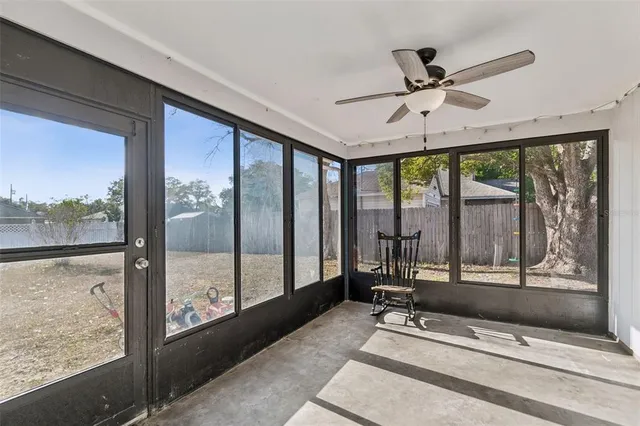 a living room with hardwood floor and large window