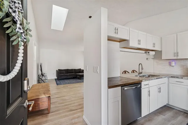 a kitchen with stainless steel appliances granite countertop a sink stove and cabinets