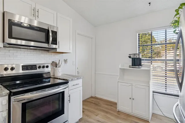 a kitchen with a stove and a microwave