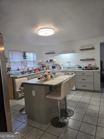 a kitchen with a sink window and cabinets
