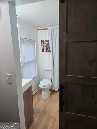 a white toilet sitting next to a bathroom sink
