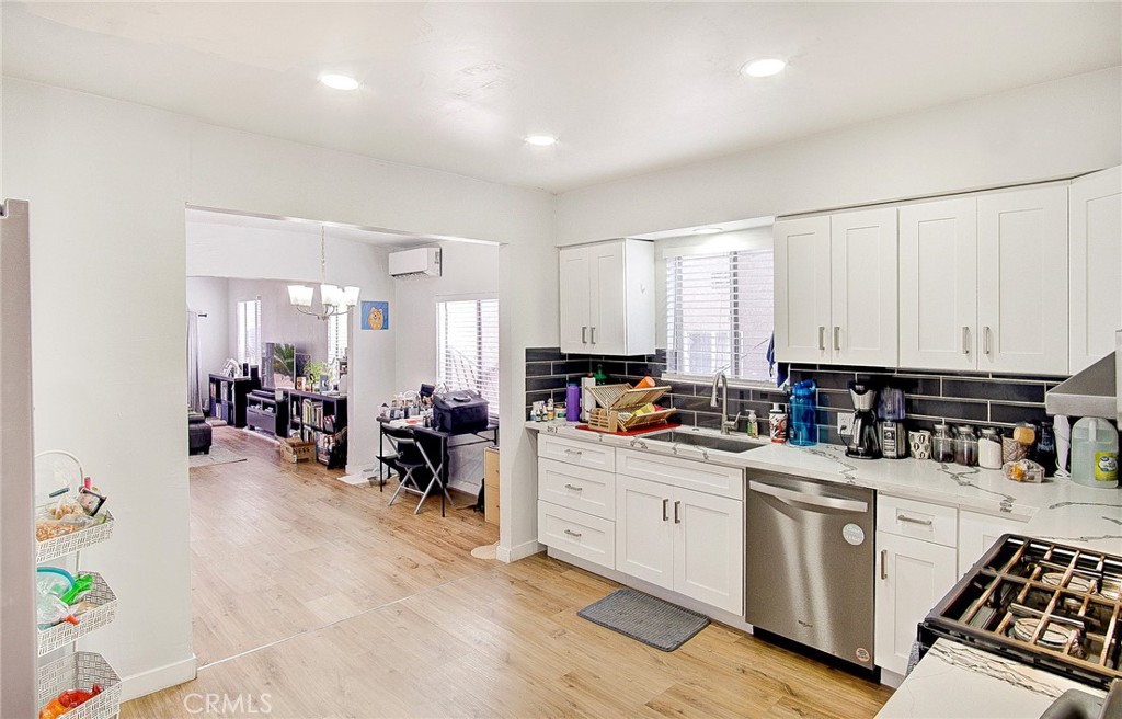 701 Westminster Avenue Alhambra, CA 91803 - Photo 12 of 35 a kitchen that has a lot of cabinets a sink and appliances in it