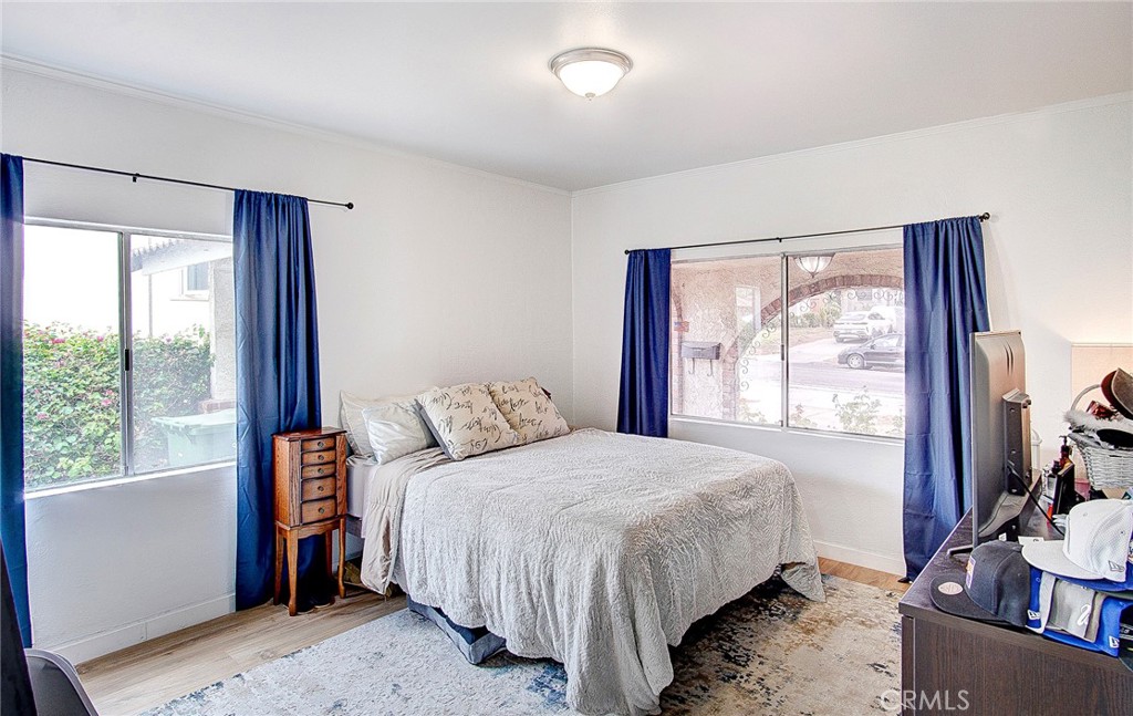 701 Westminster Avenue Alhambra, CA 91803 - Photo 16 of 35 a bedroom with a large bed and a flat tv screen on dresser