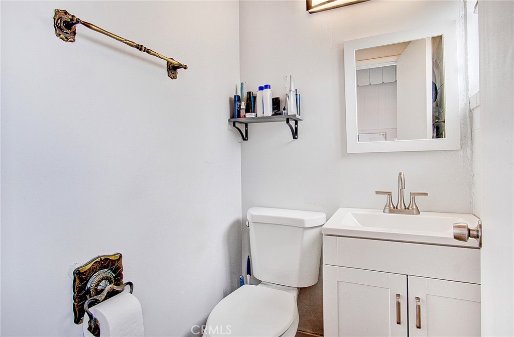 701 Westminster Avenue Alhambra, CA 91803 - Photo 18 of 35 a bathroom with a toilet sink and mirror