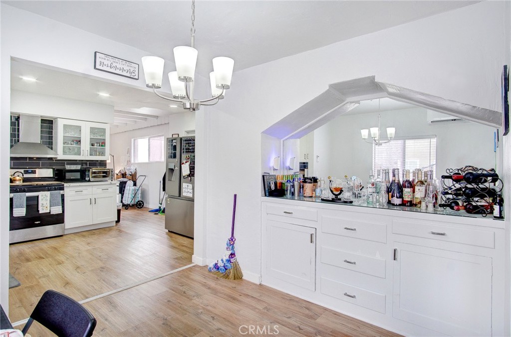 701 Westminster Avenue Alhambra, CA 91803 - Photo 9 of 35 a view of a kitchen with cabinets and wooden floor