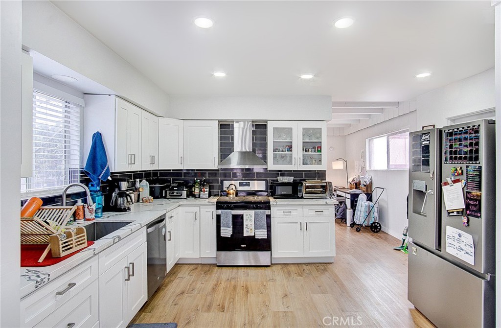 701 Westminster Avenue Alhambra, CA 91803 - Photo 10 of 35 a kitchen with a sink appliances and cabinets