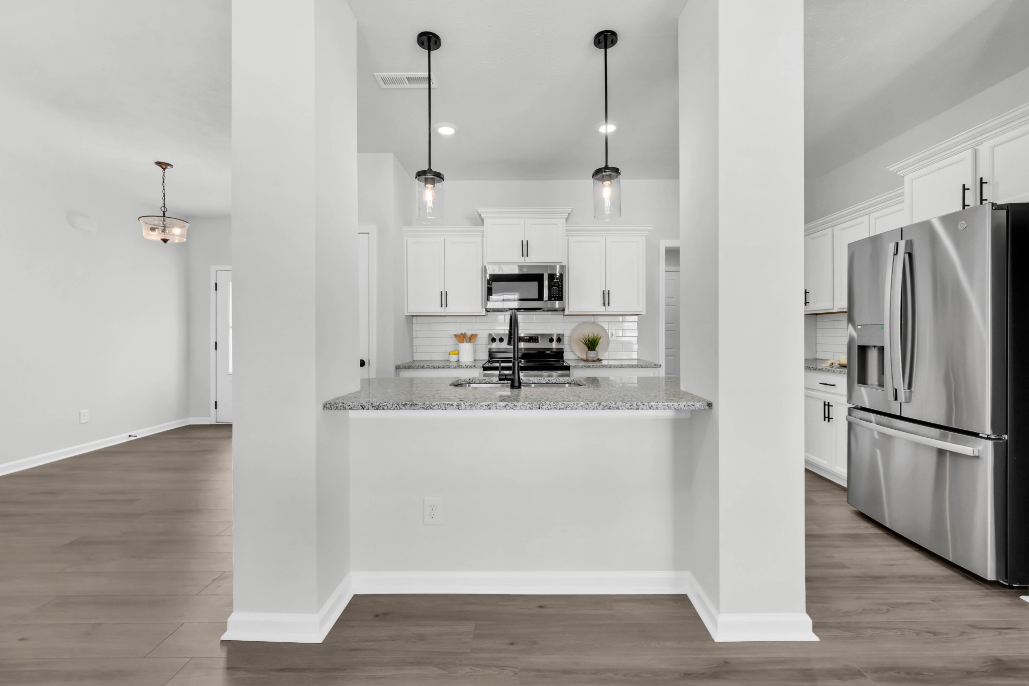 1192 Boulder Pass Road Clarksville, TN 37040 - Photo 12 of 26 a kitchen with stainless steel appliances granite countertop a refrigerator a stove a sink and white cabinets