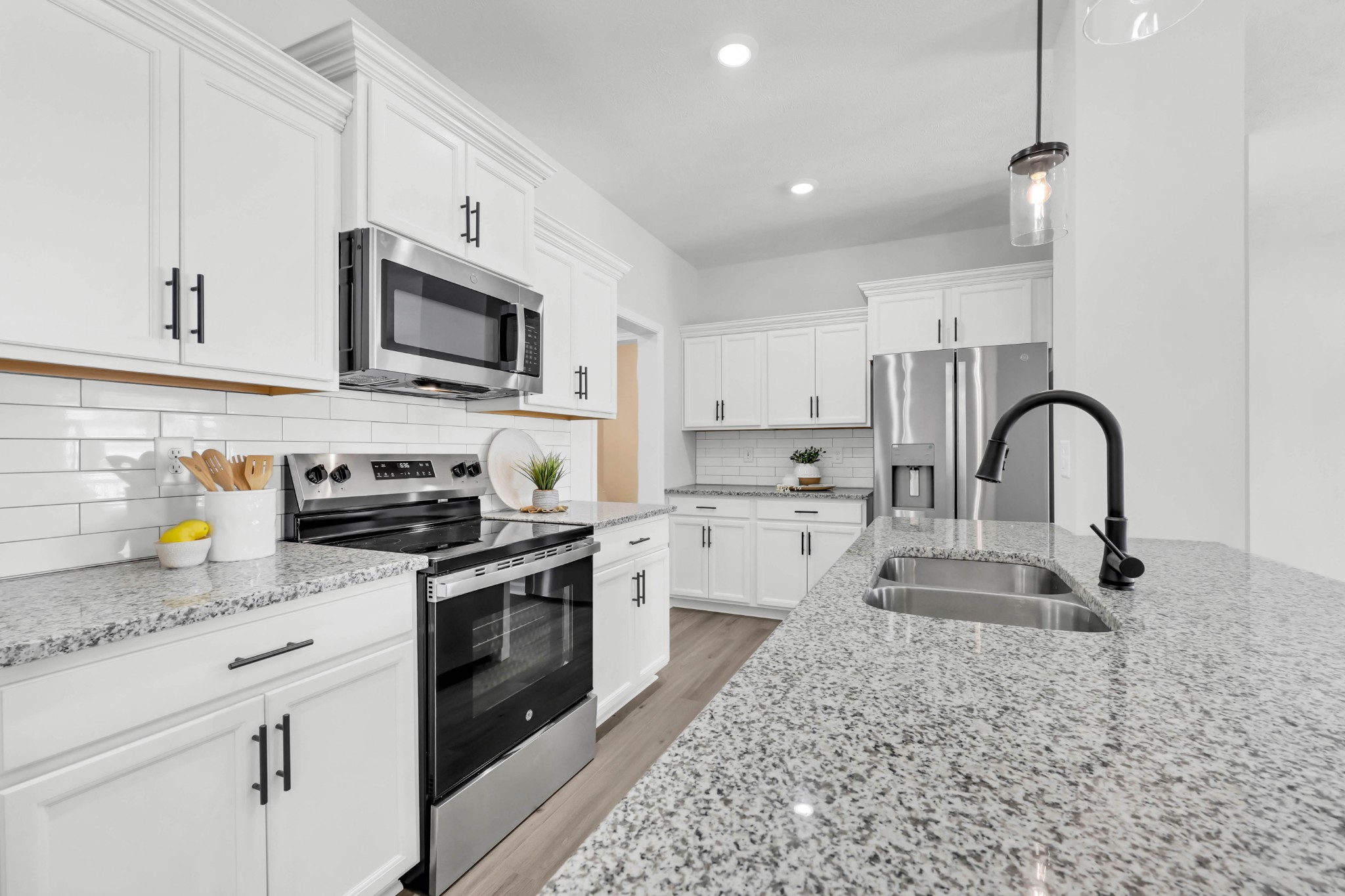 1192 Boulder Pass Road Clarksville, TN 37040 - Photo 13 of 26 a kitchen with stainless steel appliances granite countertop a stove a sink a microwave and refrigerator