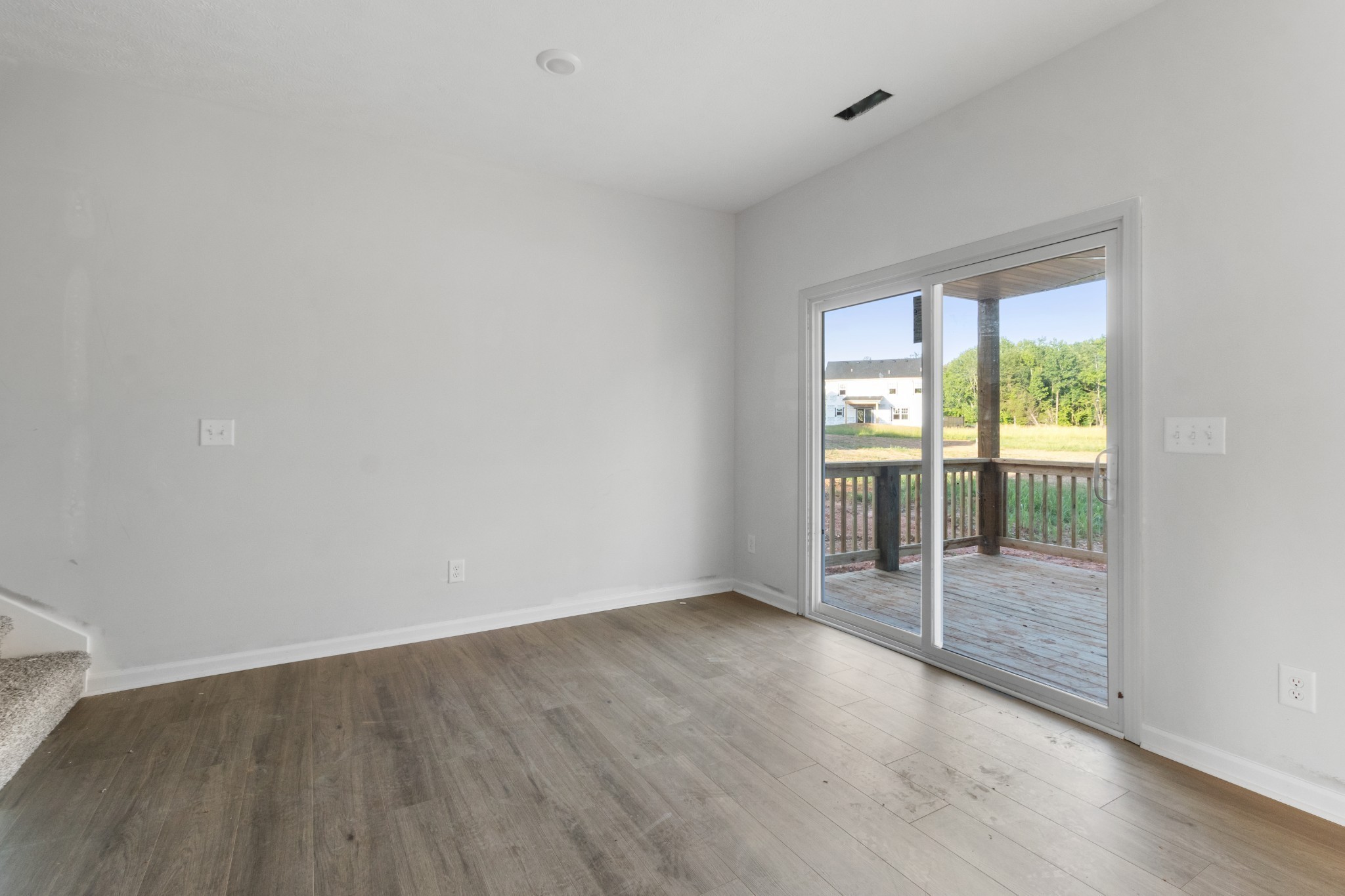 1192 Boulder Pass Road Clarksville, TN 37040 - Photo 15 of 26 an empty room with wooden floor and windows