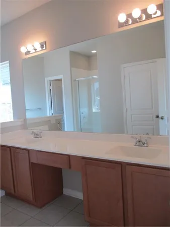 a bathroom with a sink vanity and a mirror