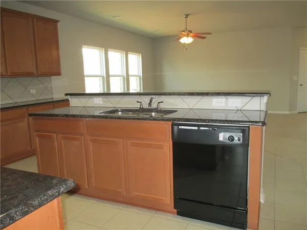 a kitchen with a sink and a refrigerator