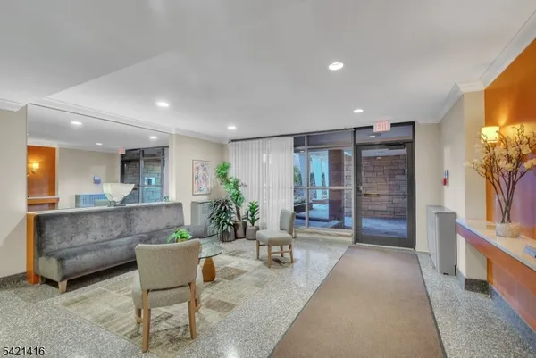 a living room with furniture a flat screen tv and a large window