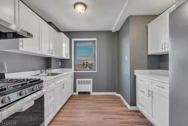 a kitchen with stainless steel appliances granite countertop a stove and a refrigerator