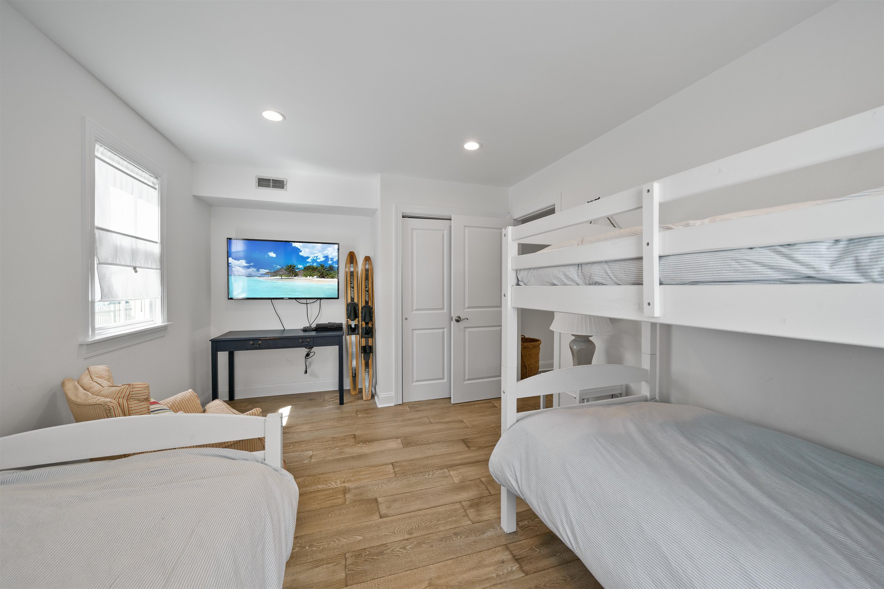 360 39th Street, Unit EAST Avalon, NJ 08202 - Photo 16 of 28 a bedroom with a bed and a flat screen tv