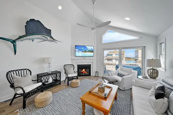 a kitchen with stainless steel appliances granite countertop a refrigerator a stove a sink a dining table and chairs